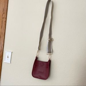 Ah•dorned bag with tan/white strap